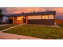 Charming single-story home featuring a combination of wood and brick exterior, complemented by a well-manicured lawn at 5304 Granby St, Denver, CO 80239