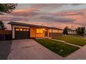 Charming single-story home featuring a combination of wood and brick exterior, complemented by a well-manicured lawn at 5304 Granby St, Denver, CO 80239