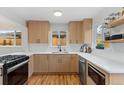 Modern kitchen features stainless steel appliances, white countertops, and wood cabinets at 3377 N Krameria St, Denver, CO 80207