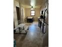 Functional kitchen and dining area with tile floors, wood cabinets and a small table at 7488 Quivas St, Denver, CO 80221