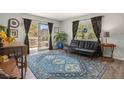 Stylish living room with hardwood floors, large windows, and access to a private balcony at 140 E Highline Cir # 304, Centennial, CO 80122
