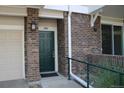 Close-up view of the front door with brick surround and well-maintained exterior at 1659 Harris St, Superior, CO 80027