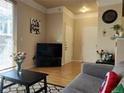 Inviting living room with wood floors, large window, stylish decor, and comfortable gray couch for relaxing and entertaining at 1659 Harris St, Superior, CO 80027
