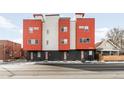 Modern multi-unit building with brick and orange facade, showcasing contemporary architecture at 1912 W 38Th Ave, Denver, CO 80211
