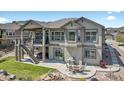 A backyard featuring a patio, stairs to an upper balcony, and an outdoor fire pit area at 3255 Waterfront Dr, Monument, CO 80132