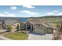 Aerial shot of a home with a three-car garage near a lake, showcasing its stunning views at 3255 Waterfront Dr, Monument, CO 80132