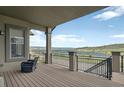 Relax on the porch overlooking water views, featuring neutral tones and rod iron details at 3255 Waterfront Dr, Monument, CO 80132