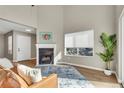Cozy living room featuring a fireplace, picture window, and wood-look floors at 1820 Newland Ct # 201, Lakewood, CO 80214