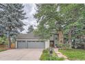 Beautiful two-story home boasting a three-car garage, mature landscaping, and a brick chimney at 8216 S Krameria Way, Centennial, CO 80112