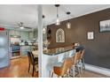 Eat-in kitchen area featuring stylish lighting, breakfast bar and adjacent dining space at 7040 E Girard Ave # 406, Denver, CO 80224