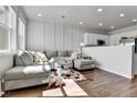 Cozy living room with a plush gray sectional sofa and abundant natural light from a window at 6459 N Dunkirk St, Denver, CO 80249