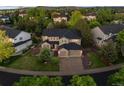 Aerial view of a well-maintained two-story home with lush landscaping in a quiet neighborhood at 10524 Serengeti Dr, Lone Tree, CO 80124