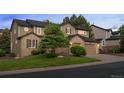 This two-story home offers a manicured lawn and mature trees at 10524 Serengeti Dr, Lone Tree, CO 80124