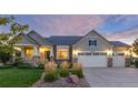 Attractive two-story home showcasing a three-car garage, stone accents, and manicured landscaping at 27235 E Lakeview Pl, Aurora, CO 80016