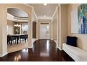 Elegant foyer boasts hardwood floors, arched doorways, and views into the formal dining room at 27235 E Lakeview Pl, Aurora, CO 80016