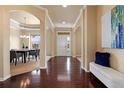 Elegant foyer featuring hardwood floors, arched doorways, and a view into the dining room at 27235 E Lakeview Pl, Aurora, CO 80016