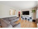 Spacious living room with a comfortable gray sectional sofa and stylish decor at 1817 S Perry Way, Denver, CO 80219