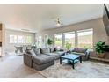 Open concept living room with large windows, modern furniture, and views of the natural landscape at 9571 Yucca Ct, Arvada, CO 80007