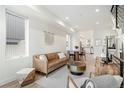 Bright living room showcasing open layout, modern decor, and seamless flow to the kitchen at 2012 W 46Th Ave, Denver, CO 80211