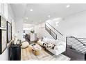 Open-concept living room featuring sleek design, modern staircase, and hardwood floors at 2830 W 32Nd Ave, Denver, CO 80211