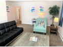 Comfortable living room with a black futon, modern chair, and stylish coffee table at 2200 W Moffat Pl, Denver, CO 80221