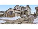 Charming two-story home with a two-car garage, stone accents, and a well-maintained driveway at 17402 W 93Rd Pl, Arvada, CO 80007