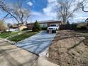 A well-maintained brick house with a driveway and landscaped yard at 12116 W Texas Dr, Lakewood, CO 80228