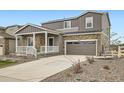 Beautiful two-story home with stone accents and a well-maintained front yard at 5256 Trails Edge Ln, Castle Rock, CO 80104