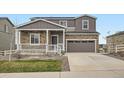 Charming two-story home with a stone facade and inviting front porch at 5256 Trails Edge Ln, Castle Rock, CO 80104