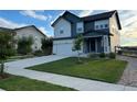 Two-story home with an attached garage, neat front lawn and close proximity to neighboring homes at 12901 Crane River Dr, Longmont, CO 80504