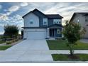 Charming two-story home with a spacious driveway and lush green lawn at 12901 Crane River Dr, Longmont, CO 80504