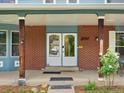 Inviting front porch with double doors, brick accents, and decorative plants at 10978 Roseanna Dr, Northglenn, CO 80234