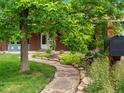 Landscaped front yard with a stone pathway leading to the entrance at 10978 Roseanna Dr, Northglenn, CO 80234