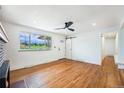 Bright room featuring hardwood floors, a sliding barn door, and a window with great views at 2280 Sherrelwood Dr, Denver, CO 80221