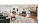 Bright, open-concept living space featuring hardwood floors and seamless flow to the dining and kitchen areas at 3383 S Ogden St, Englewood, CO 80113