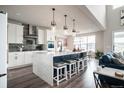 Spacious kitchen with a large island, quartz countertops, stainless steel appliances, and gray subway tile at 695 Simmental Loop, Castle Rock, CO 80104