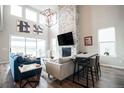 Inviting living room features a floor-to-ceiling stone fireplace, large windows, and stylish decor at 695 Simmental Loop, Castle Rock, CO 80104