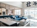 Bright open-concept living room features a modern design, lots of natural light, and direct access to outdoor patio at 695 Simmental Loop, Castle Rock, CO 80104