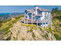 This hillside home includes a large deck perfect for entertaining and enjoying the views at 14440 Eagle Vista Dr, Littleton, CO 80127