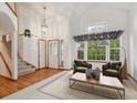 Bright and airy living room boasts hardwood floors, a vaulted ceiling, and large windows at 248 Summit Trl, Broomfield, CO 80020