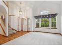 Bright and airy living room boasts hardwood floors, a vaulted ceiling, and large windows at 248 Summit Trl, Broomfield, CO 80020