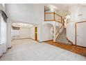 Spacious living room with hardwood floors, a staircase and ample natural light at 248 Summit Trl, Broomfield, CO 80020