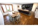 Open-concept living room featuring hardwood floors, ample natural light, and comfortable seating at 3111 W Bails Pl, Denver, CO 80219