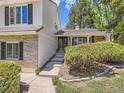 Inviting entrance with brick accents, stone walkway, and lush landscaping leading to the front door at 6379 S Jasmine Way, Centennial, CO 80111