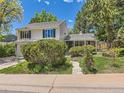 Two-story home with well-maintained front yard, mature trees, and inviting walkway leading to the front door at 6379 S Jasmine Way, Centennial, CO 80111