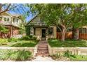 Beautiful exterior view of a home with a well-maintained lawn, a porch, and lovely landscaping at 368 S Humboldt St, Denver, CO 80209