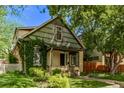 Exterior view of a home with green shingle, covered porch, and a well-manicured lawn at 368 S Humboldt St, Denver, CO 80209