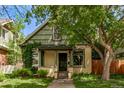 Charming home featuring a covered porch, lush landscaping, and mature trees at 368 S Humboldt St, Denver, CO 80209