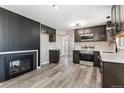 A well-lit kitchen features stainless steel appliances, granite countertops and hardwood floors at 6913 Teller Ct, Arvada, CO 80003