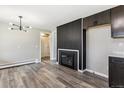 Living room featuring a fireplace, recessed lighting, hardwood floors, and neutral colored walls at 6913 Teller Ct, Arvada, CO 80003